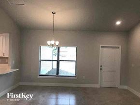 Fort Myers house for rent - an empty living room with a window and a door