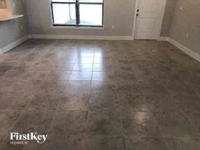 Fort Myers house for rent - an empty room with tile flooring and a window