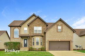 Clarksville house for rent - a brick house with a garage and a blue sky