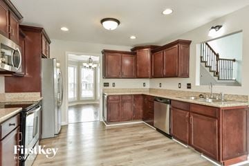 Clarksville house for rent - a kitchen with wooden cabinets and stainless steel appliances