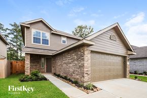 Conroe house for rent - A house with a garage and a driveway is shown.
