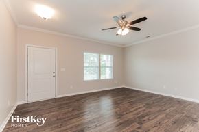 Gastonia house for rent - the spacious living room with wood floors and a ceiling fan