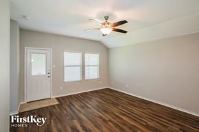 Fort Worth house for rent - an empty room with a ceiling fan and a door