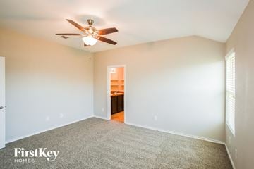 Fort Worth house for rent - a living room with a ceiling fan and a carpet