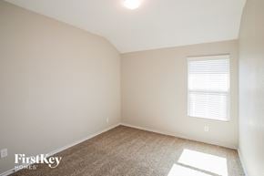 Fort Worth house for rent - a bedroom with white walls and carpet and a window