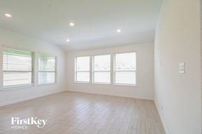 Rosharon house for rent - A spacious room with a FirstKey HOMES logo on the bottom left.