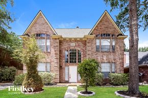 Houston house for rent - A brick house with a white door and windows.