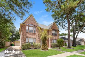 Houston house for rent - A brick house with a tree in front of it.