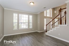 Houston house for rent - A spacious room with a staircase and a window.