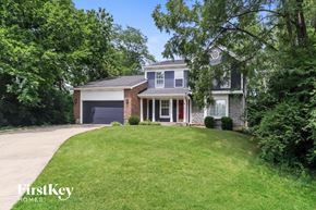 Sharonville house for rent - a house with a lawn and a purple garage door