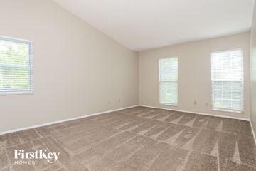 Sharonville house for rent - the living room of a home with carpet and two windows