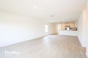 San Antonio house for rent - an empty living room and kitchen with wood floors