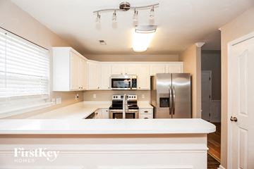 Charlotte house for rent - A kitchen with a white counter top and stainless steel appliances.