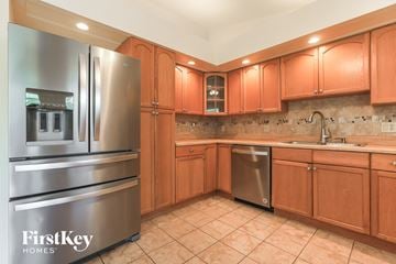 Englewood house for rent - a kitchen with wooden cabinets and stainless steel appliances