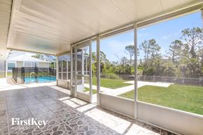 Englewood house for rent - a patio with glass doors and a pool in the backyard