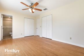 Englewood house for rent - a living room with a wood floor and a ceiling fan