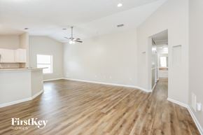 Jacksonville house for rent - the living room and dining room with wood flooring and white walls