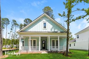 Summerville house for rent - A small house with a porch and a tree in front of it.