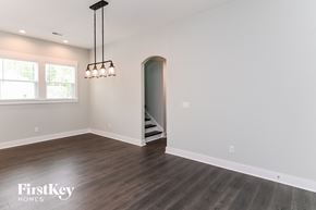 Summerville house for rent - A room with wooden floors and a chandelier hanging from the ceiling.