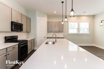Summerville house for rent - A kitchen with a white countertop and a stove top oven.