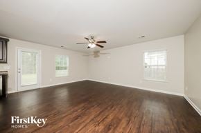 Lexington house for rent - an empty living room with wood floors and a ceiling fan