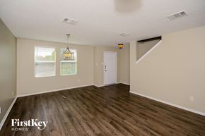 Anna house for rent - A room with wooden floors and a white door.