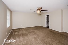 Anna house for rent - A spacious room with a ceiling fan and carpeted floor.