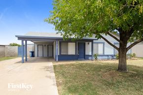 Tempe house for rent - a small blue and white building with a tree in front of it