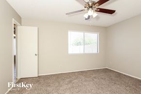 Tempe house for rent - a bedroom with a ceiling fan and a closet