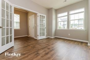 Summerville house for rent - A room with wooden floors and a large window.