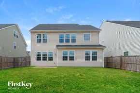 Summerville house for rent - A house with a fence and a grassy yard.