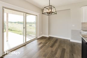 Platte City house for rent - an empty living room with a sliding glass door to a patio