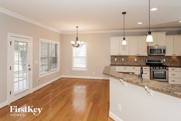 Winston Salem house for rent - A kitchen with a wooden floor and a counter top.