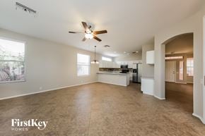 Tucson house for rent - A spacious living room with a kitchen in the background.