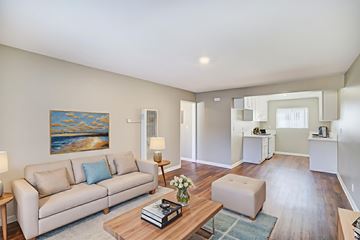 Banning apartment for rent - A living room with a couch, coffee table, and a painting on the wall.