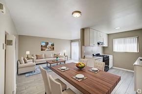 Banning apartment for rent - A modern dining room with a wooden table set for two.