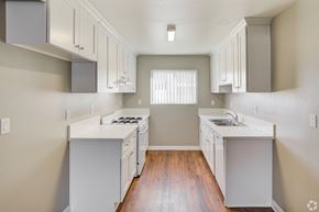 Banning apartment for rent - A kitchen with white appliances and cabinets.
