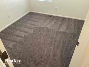 Commerce City house for rent - a room with a carpeted floor and a door