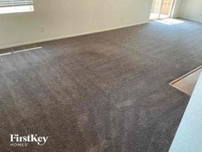 Commerce City house for rent - a carpeted floor in a room with a window