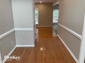 Charlotte house for rent - A room with wooden floors and white walls.