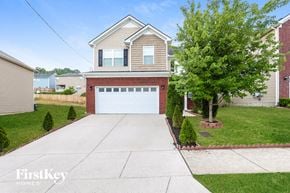 Antioch house for rent - a white garage door in front of a brick house