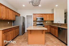 San Tan Valley house for rent - a kitchen with wooden cabinets and stainless steel appliances
