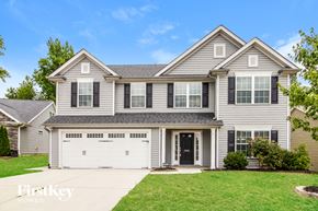 Thomasville house for rent - A two-story house with a garage is showcased in the image.