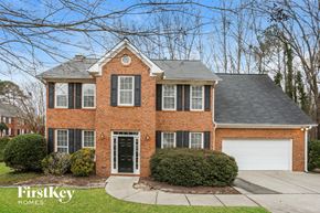Powder Springs house for rent - A brick house with a black door and windows.