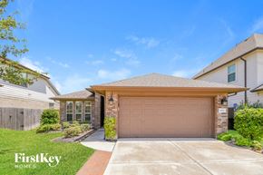 League City house for rent - a garage door in front of a house
