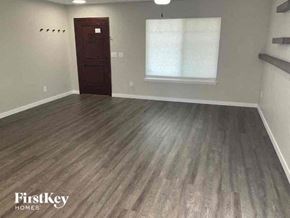 Denver house for rent - an empty living room with a wooden floor