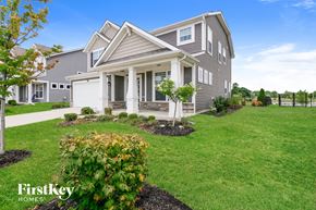 Brownsburg house for rent - A house with a grey roof and a white fence.