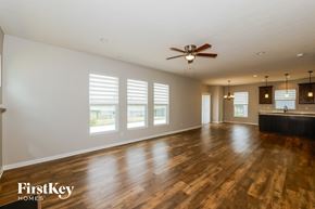 Brownsburg house for rent - A spacious room with wooden floors and a ceiling fan.
