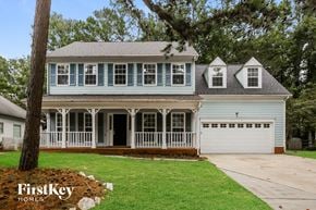 Charlotte house for rent - a white house with a white front porch and a white garage door