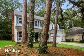 Charlotte house for rent - a white house with three trees in front of it